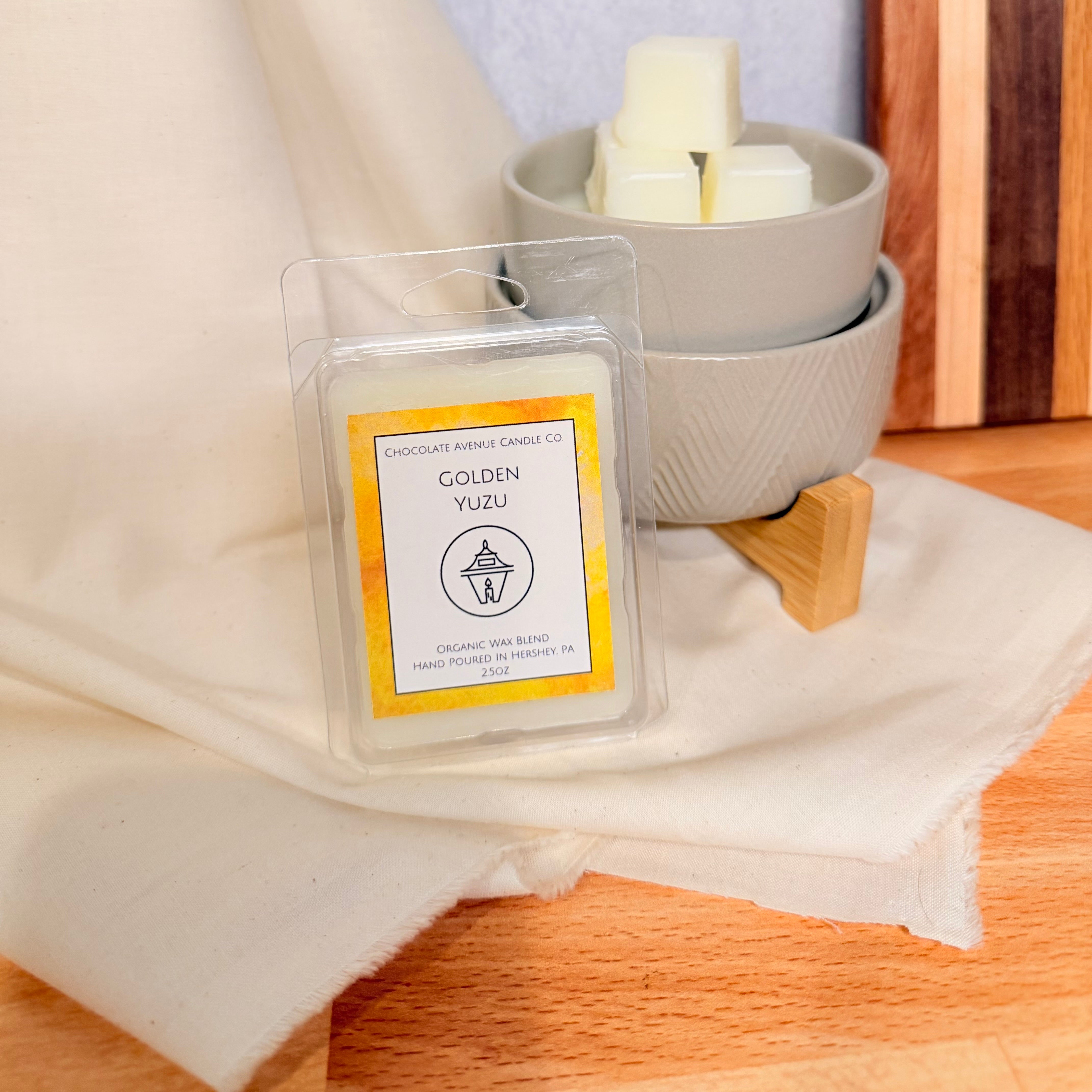 Golden Yuzu wax melt with citrus, jasmine, amber, sea salt, and cedar notes.