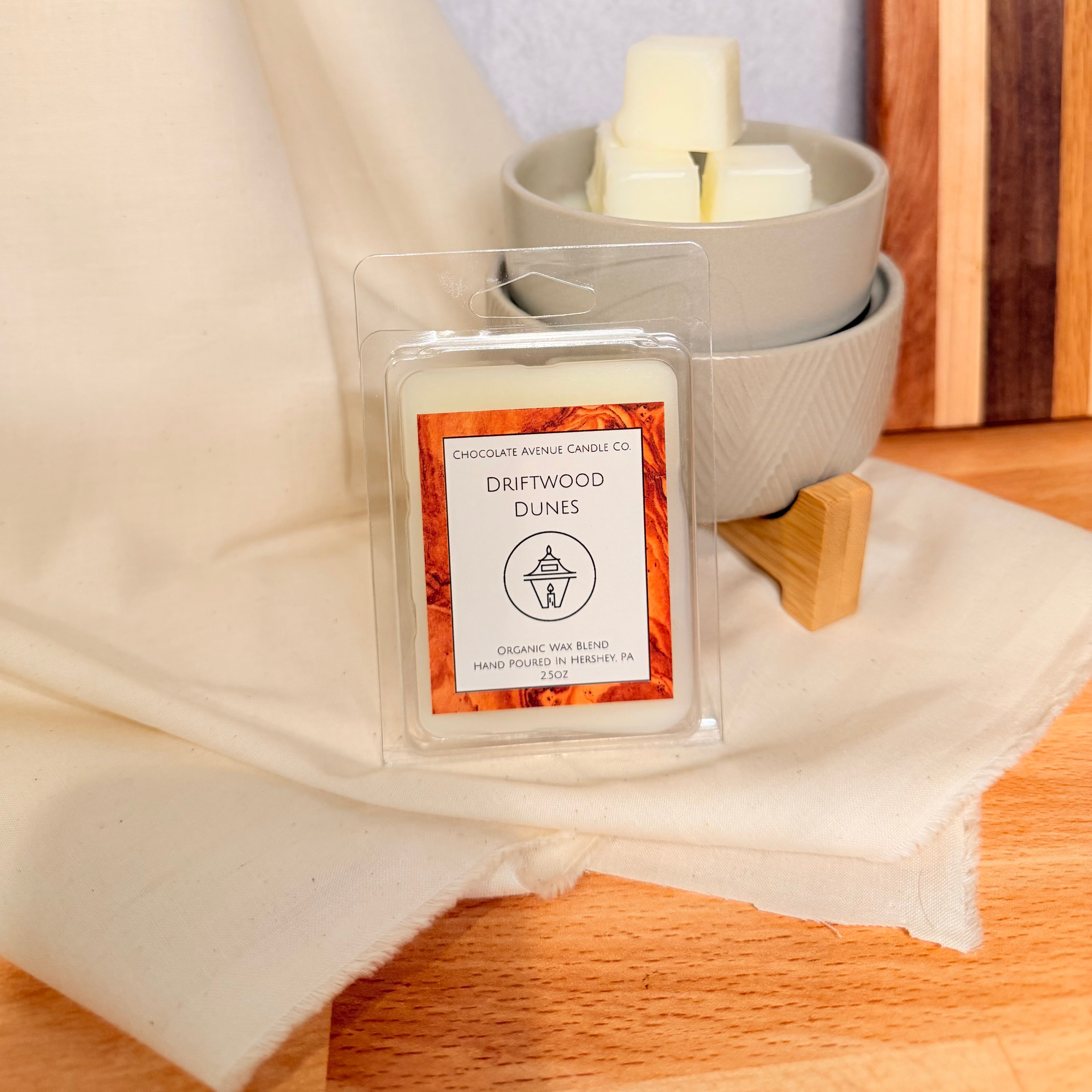 Driftwood Dunes wax melt with driftwood, pine needles, and ocean air notes.