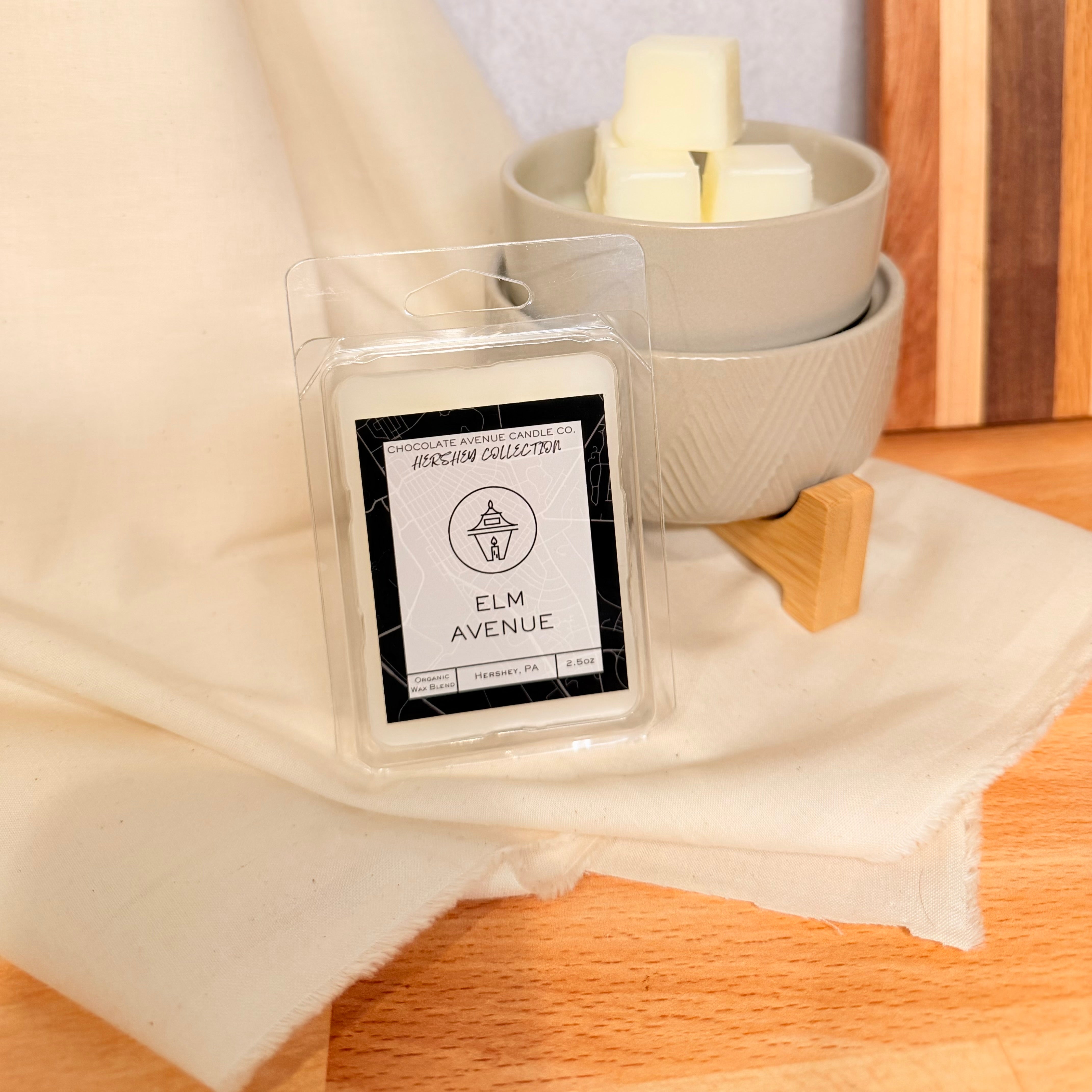 Elm Avenue wax melt with warm palo santo and soft wood notes.