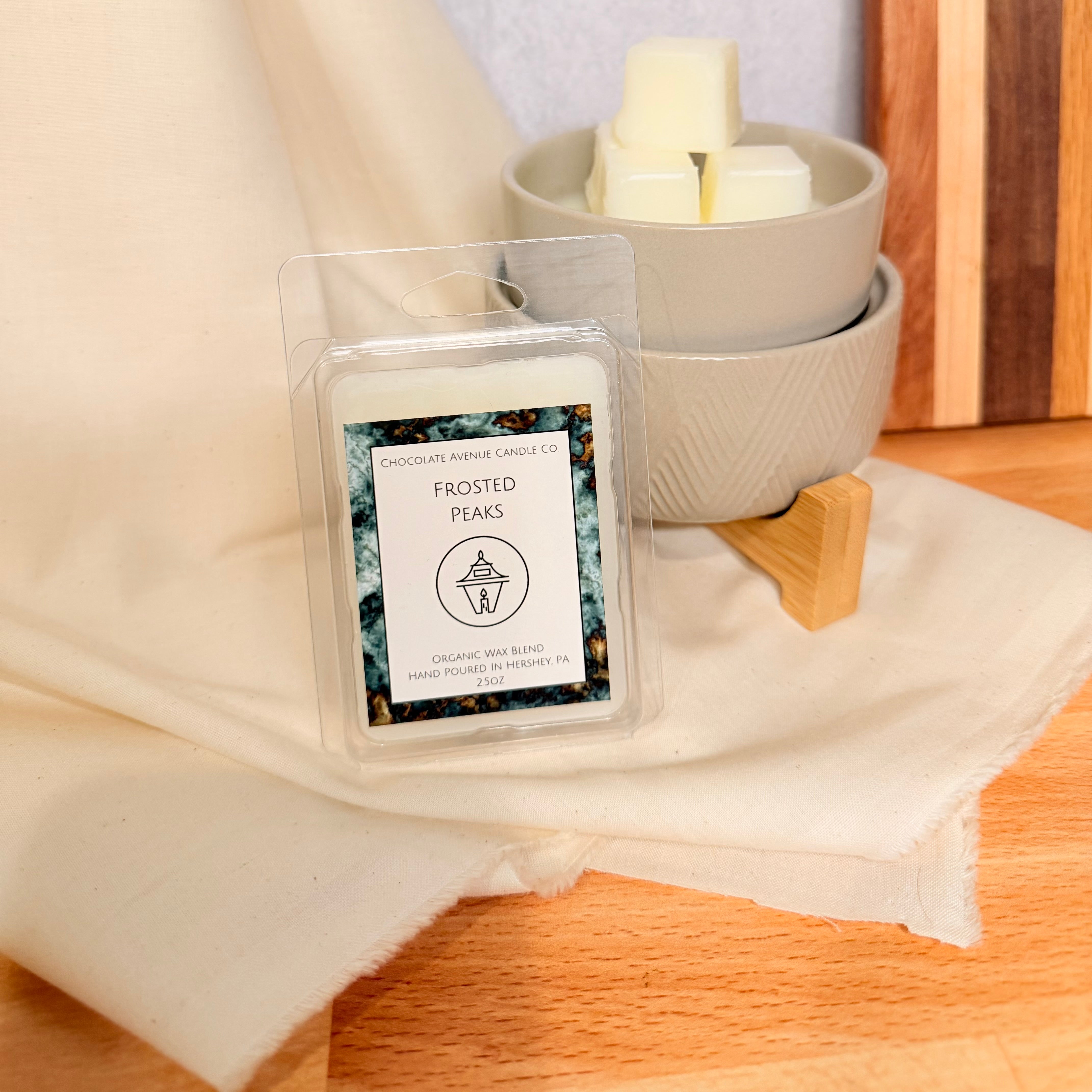 Frosted Peaks wax melt with pine, juniper, and peppermint winter mountain notes.