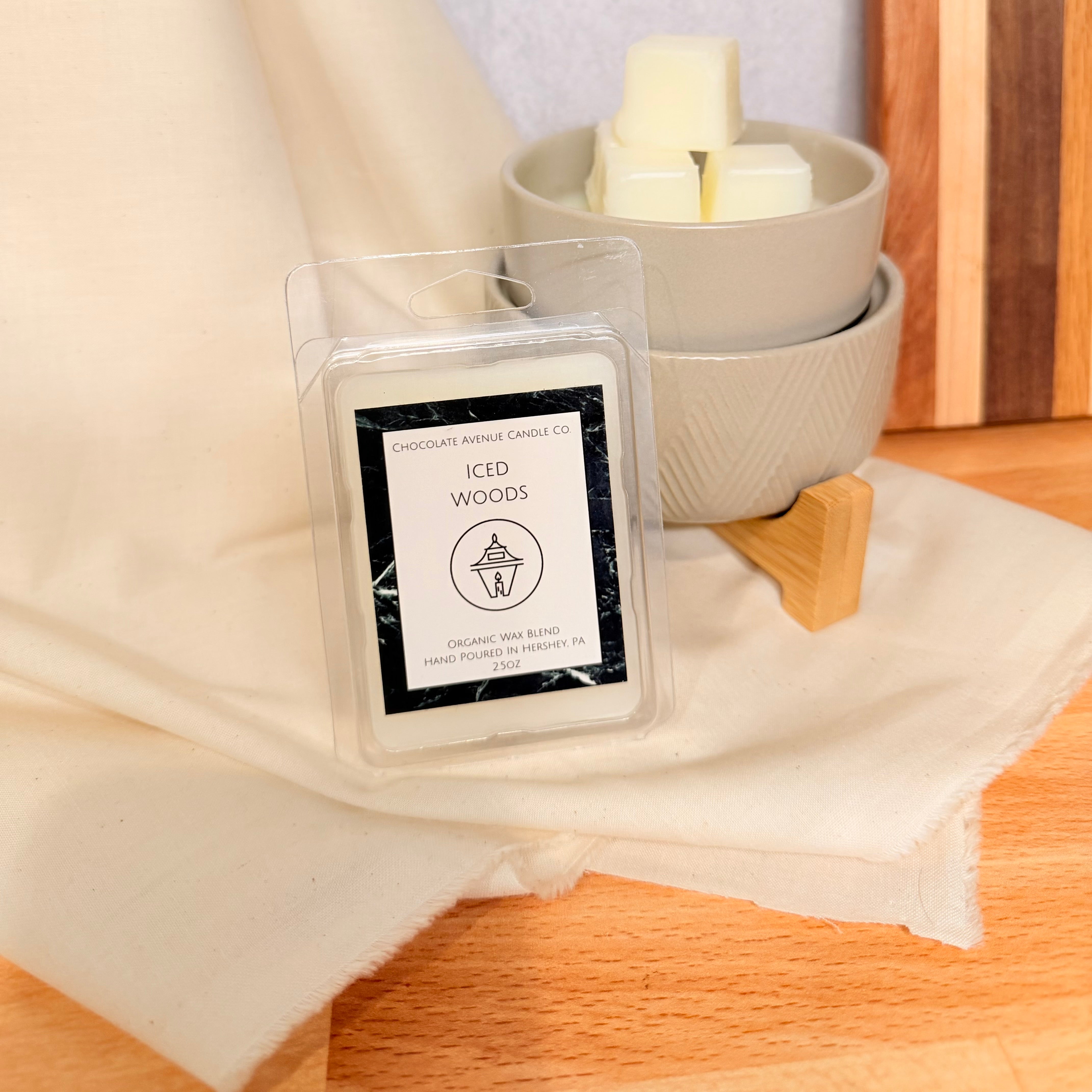 Iced Woods wax melt with lavender, vanilla, smoky wood, and soft musk notes.